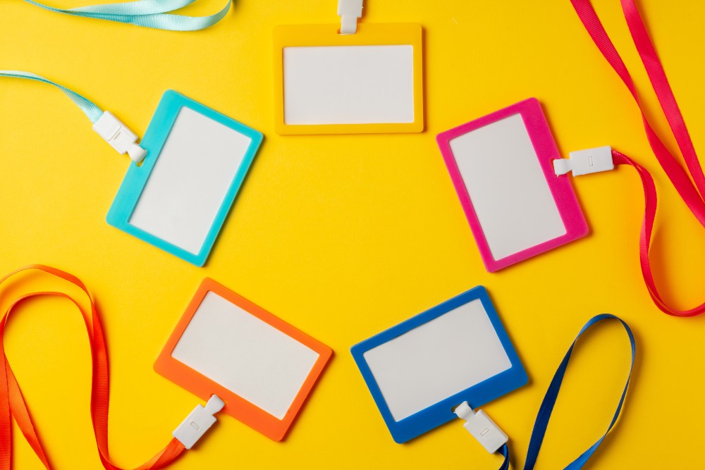 colored-blank-nametags-on-strings-on-yellow-backgr-2024-02-07-16-06-19-utc