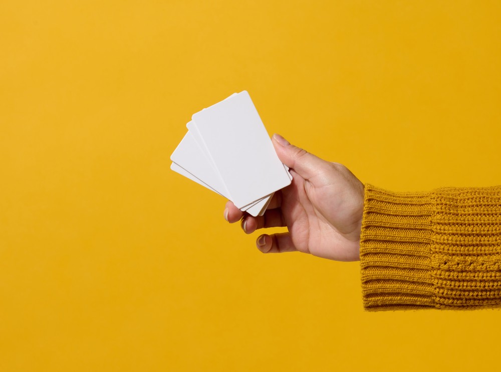 female-hand-holding-empty-paper-white-business-car-2023-11-27-05-13-35-utc